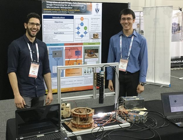 Prof. Eric Diller's students, Christopher Lucasius and Lucas Botelho, pose with their microrobotics system, which won second place in the “Autonomous Manipulation and Accuracy Challenge” event at the Mobile Microrobotics Challenge. Photo courtesy Microrobotics Lab. 